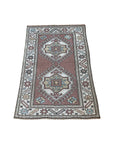 handwoven vintage rug with faded blush, blues, gold and cream