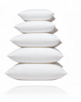 A stack of white feather pillow inserts