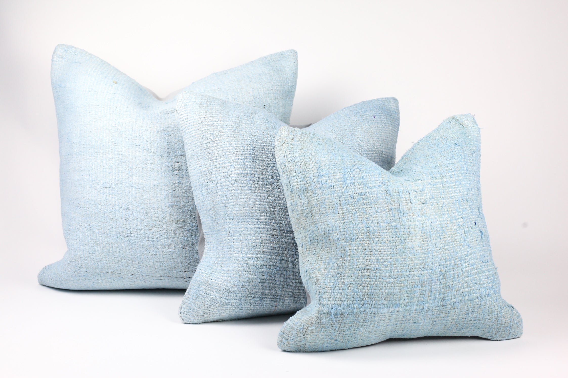 three light blue hemp pillows