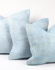 three light blue hemp pillows